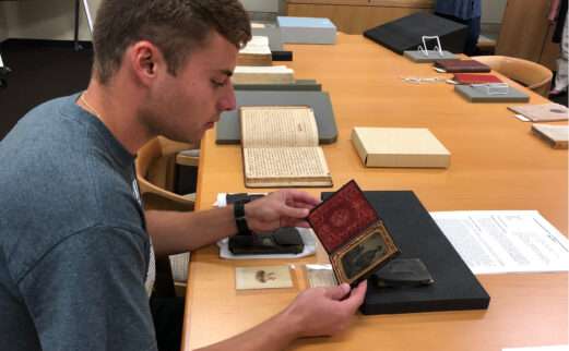 Student inspects framed photograph of Civil War soldier