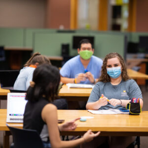 Masked students at the library