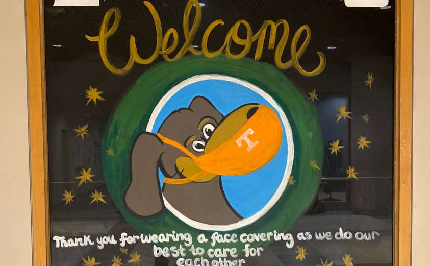 Painted image of Smokey wearing a mask that reads "Libraries Welcome, thank you for wearing a face covering"