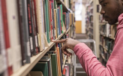 Student looking for books in John C. Hodges Library