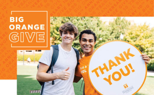 Big Orange Give -- two young men display a "thank-you" sign