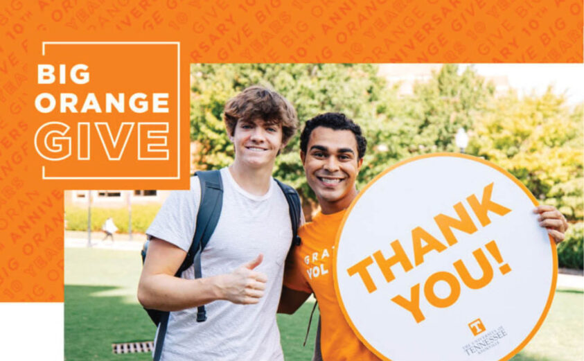 Big Orange Give -- two young men display a "thank-you" sign