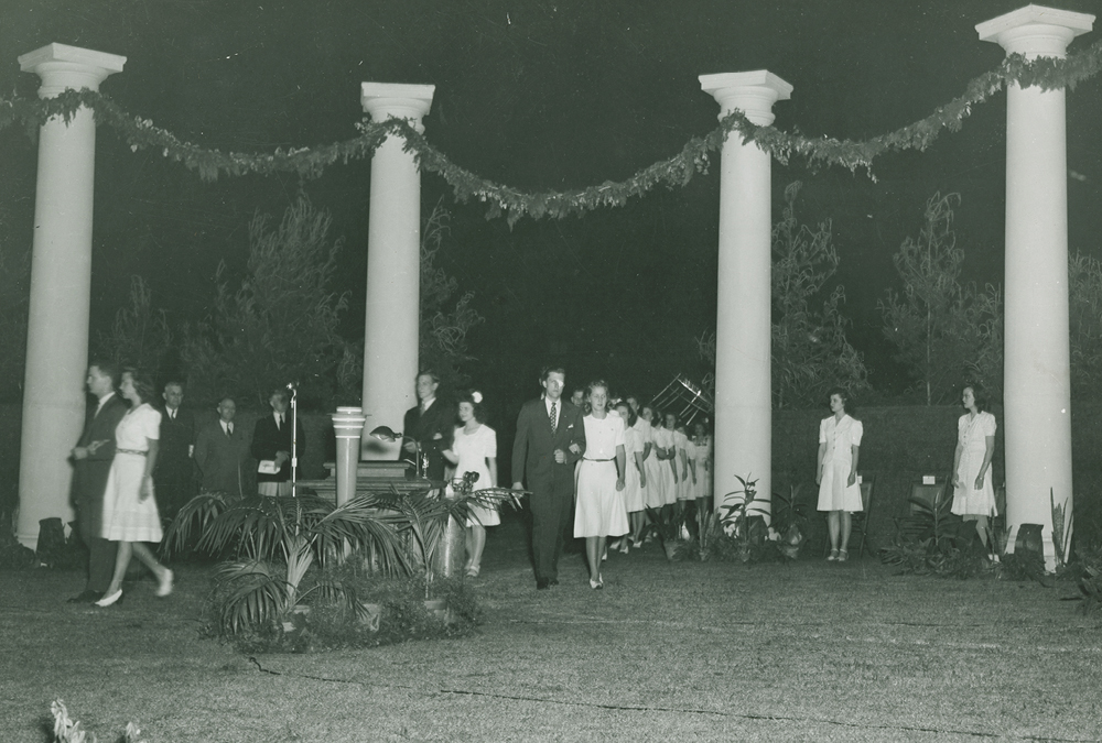 Aloha Oe, 1944. Seniors march through Grecian columns installed on Shields-Watkins Field.