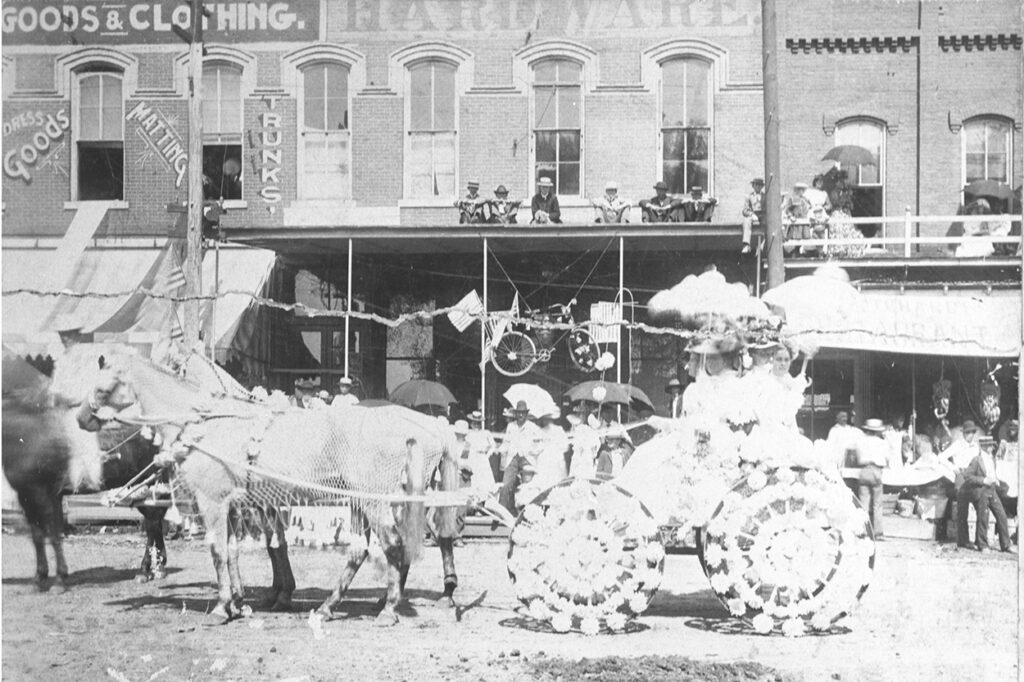Fourth of July parade, Dyersburg, Tenn., 1899. Shows a decorated horse-drawn wagon with women in it.