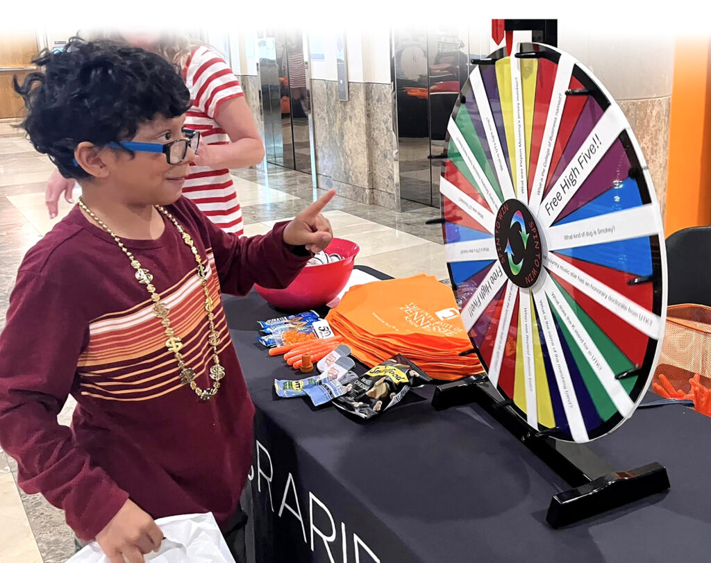 An Algood Middle School student spins the wheel for prizes at a 2ndBRIDGE tabling event.