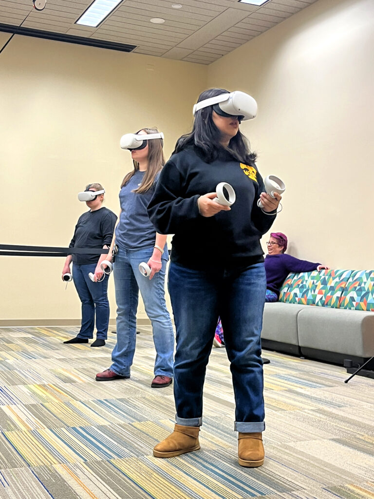 Students try out virtual reality goggles in The Studio.